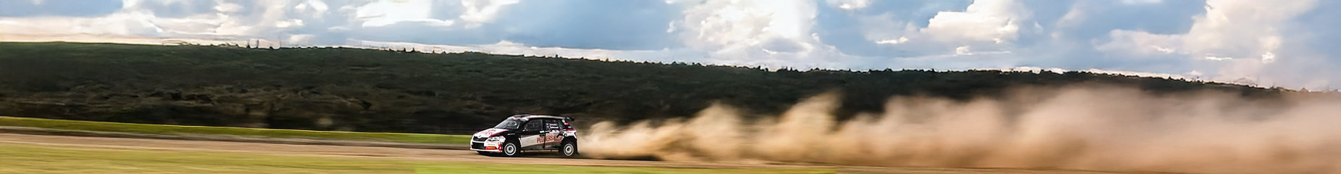 A blurry image of a field with a cloud of dustAI-generated content may be incorrect.